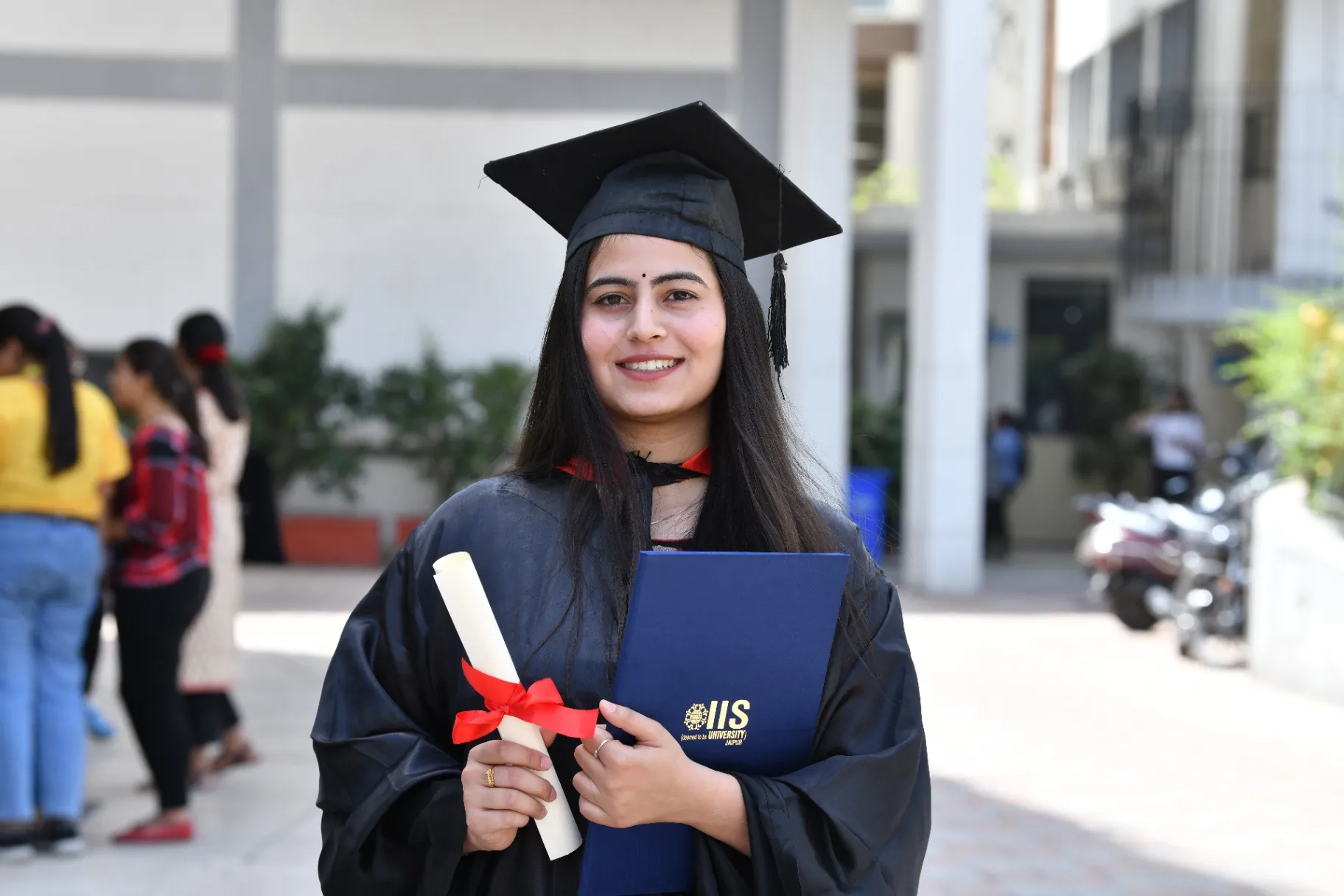 Female graduate with degree at IIS University Jaipur convocation ceremony for girls education